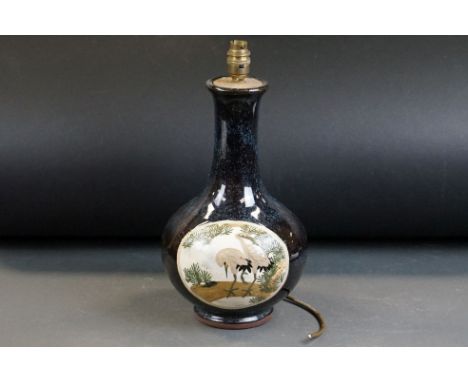 20th Century Pottery bottle vase with relief moulded stork panel decoration on a mottled blue glaze ground, converted to a ta