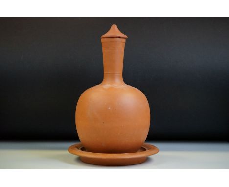 Watcombe of Torquay terracotta bottle vase &amp; cover, ribbed decoration to neck, 27cm high (lid a/f), raised on a Watcombe 