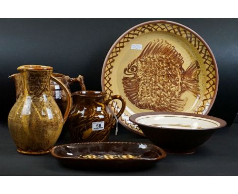 Group of slipware pottery to include an early 20th century slipware charger with fish decoration &amp; geometric border (38cm