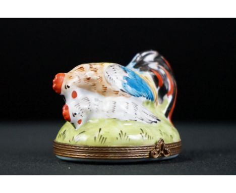 An decorative enamel trinket box in the form of a chicken and cockerel. 