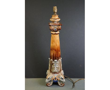 Doulton Lambeth Style lamp base of brown glazed column form, with relief moulded foliate &amp; scrolling decoration, raised o
