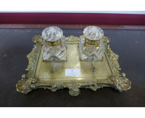 A Victorian ormolu desk stand, with two cut glass inkwells 