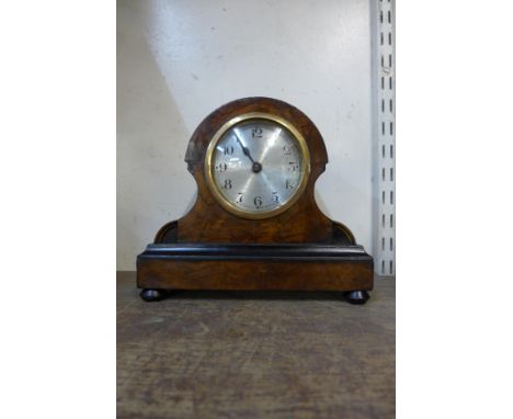 A continental walnut mantel timepiece 