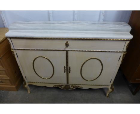 An Italian cream painted, gilt metal mounted and marble topped commode 
