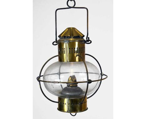 Brass hanging oil lamp, the glass shade enclosed within wirework frame, 40cm high approx,