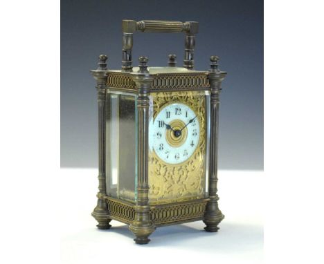 Late 19th Century French brass carriage clock having a cream Arabic chapter ring dial within gilt foliate and bird decorated 