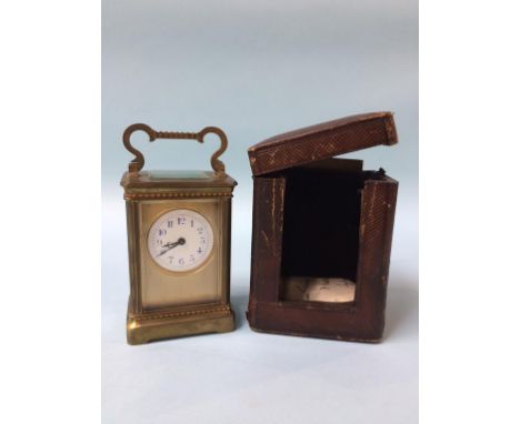 A carriage clock and fitted travelling case