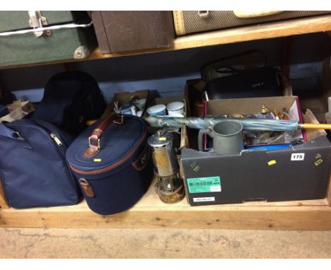 A shelf of assorted, to include a Miners lamp