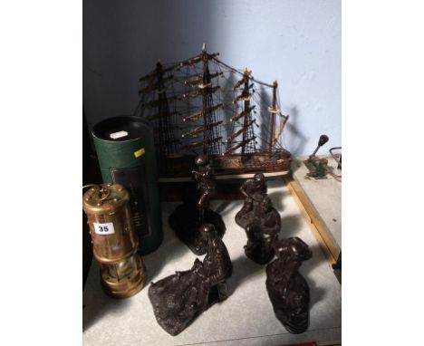 A Miners lamp, model galleon and five various figures