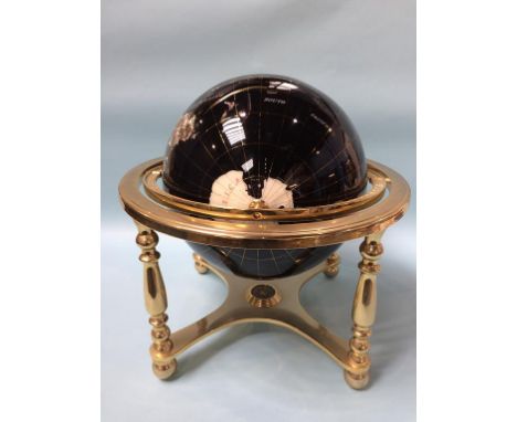 A mineral terrestrial globe on stand