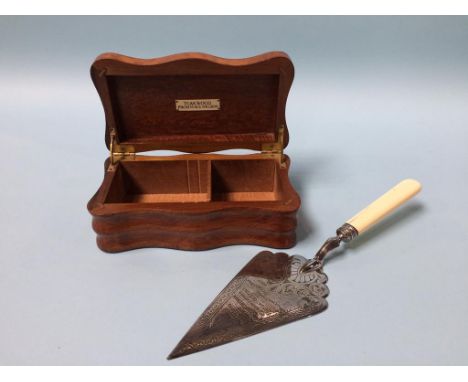 A silver plated presentation trowel, dated 1882 and a teakwood box from H. M. S. Nelson