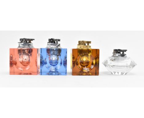 A collection of four retro 1970s glass table cigarette lighters. The lot comprising four matched Art Deco style glass lighter
