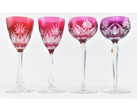 Four vintage early - mid 20th century flash cut hock glasses. The lot comprising two bulbous bowled glasses, one in purple an