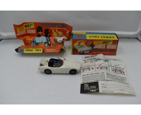 A Corgi diecast, James Bond Toyota 2000GT, in white with black interior, with bandit and driver present, on card display stan