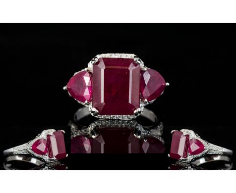 Ruby Octagon and Trillion Cut Ring, the centre octagon cut ruby being 9cts, flanked by a trillion cut ruby of 1.75 cts to eac