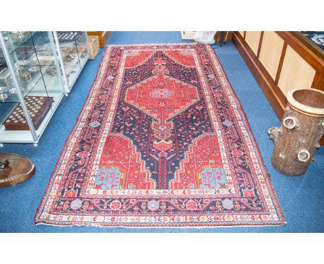 A Traditional And Very Large Afghan Wool Carpet In traditional Persian design with triple borders, central floral and foliate