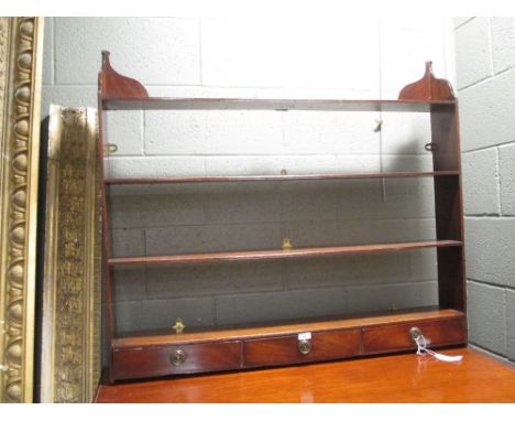 A George III mahogany wall shelf, of four tiers with three small drawers, 91cm high x 104cm wide x 14cm deep  