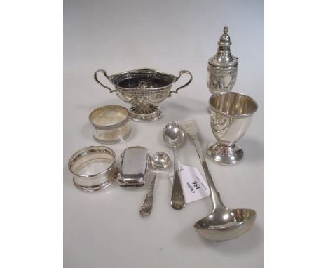 A small quantity of silver to include a pepper and mustard, two napkin rings, an egg cup and spoon, sauce ladle and vesta, (7