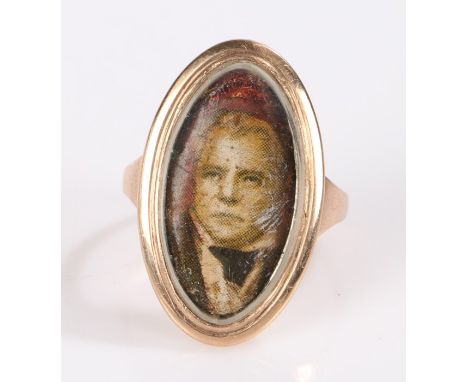 Gold coloured metal ring, the oval head set with a print depicting Sir Walter Scott FRSE FSA Scot (15th August 1771 - 21st Se