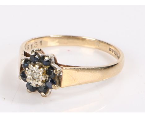 9 carat gold ring set with a central diamond chip surrounded by eight sapphires, ring size P1/2, 2.4g