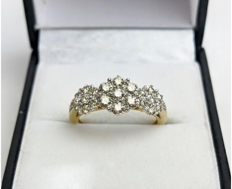 A 9CT YELLOW GOLD DIAMOND CLUSTER DRESS RING, set with three clusters of seven diamonds, total diamond weight of approx. 0.50