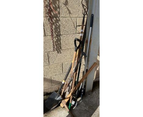 Collection of hand tools including a post digging shovel