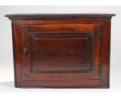 Early 18th Century Welsh antique oak mural/wall cupboard, the concave cornice above a fielded panel door enclosing a shelf, 7