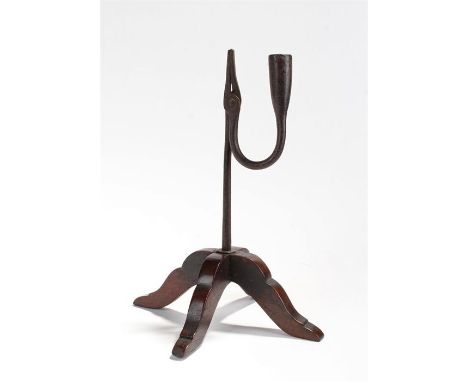 18th Century rush light holder, the iron holder raised on arched legs, 27cm high