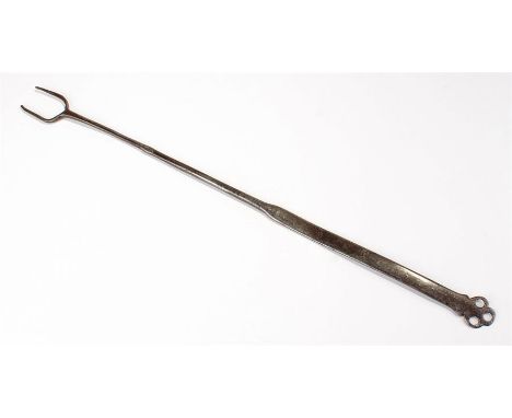 Late 18th Century steel flesh fork, with a two prong end, long shaft and pierced club end, 53cm long