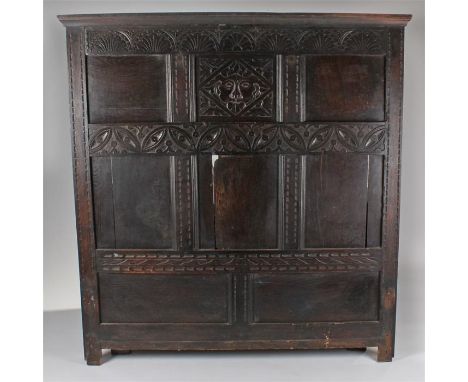 Oak headboard incorporating 17th Century panels. The central panel carved as the green man, central carved stylised leaf beam