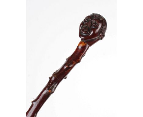 George III novelty walking stick, the head carved as a Barrister above a natural cane, 93cm long