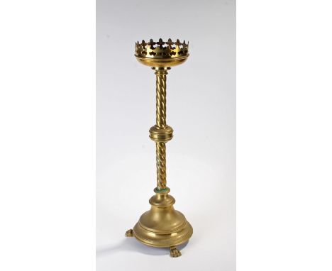 Large 19th Century brass pricket candlestick, the Gothic sconce above a twist column and wide base with paw feet, 60cm high
