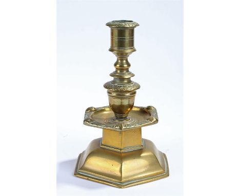 Late 19th Century brass candlestick, with leaf and face design, stepped form, 18cm high