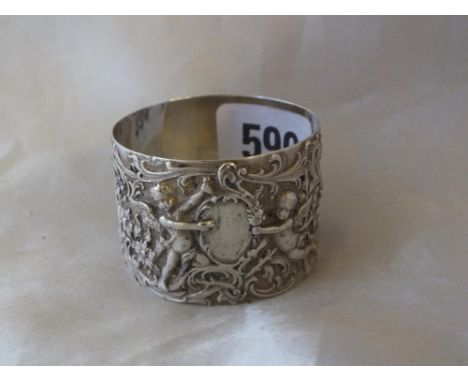 Single circular napkin ring chased with infants and foliage,  Foreign 38g.        