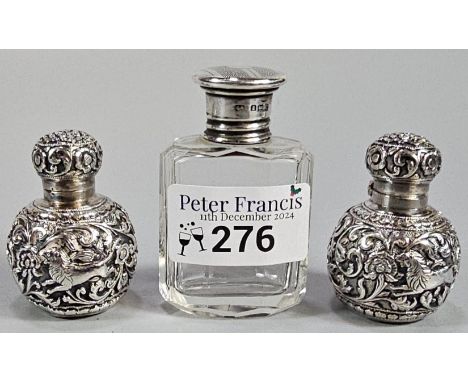 Pair of white metal Indian globular miniature scent bottles, together with a silver topped and glass scent/cologne bottle. (3
