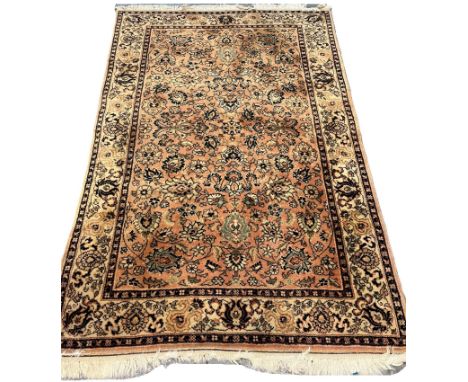 Vintage peach and cream ground Middle Eastern design floral and foliate carpet. 195x120cm approx. (B.P. 21% + VAT)