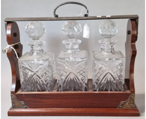 Three bottle mahogany and silver plated tantalus, marked PB &amp; S. With key.  (B.P. 21% + VAT)