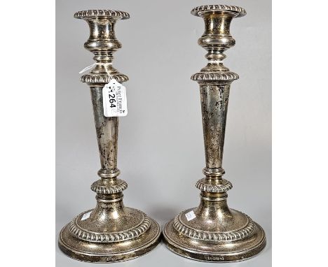 Pair of William IV silver candlesticks of baluster form with gadrooned edges on circular stepped bases. Marked 'In Memory of 