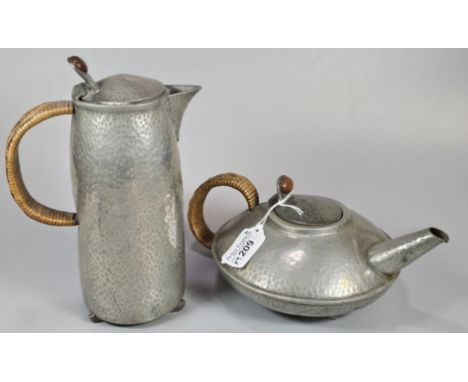 Liberty &amp; Co Tudric pewter teapot and hot water jug, of Archibald Knox design on 'Skies', both having cane handles. Marke