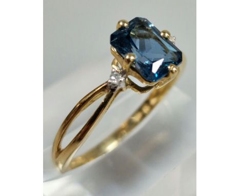 9ct gold and blue stone dress ring inset with two tiny diamond chips. 2g approx. Size R.  (B.P. 21% + VAT)
