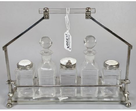 Silver plated and glass five piece cruet set on geometric stand and ball feet.  (B.P. 21% + VAT)