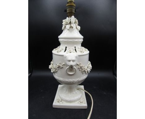 A Spanish ceramic lamp base with flowers and lion heads 40cmH