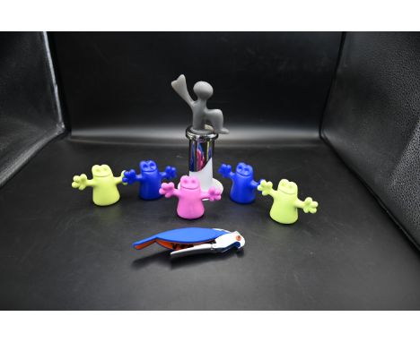 Bugatti Italy wine stopper together with 5 Alessi Little Ghost bottle stoppers and an Alessi blue parrot corkscrew