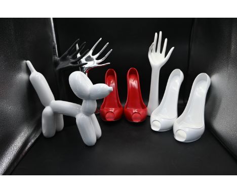 4 resin wine bottle display shoes together with 3 mannequin hand displays with a white balloon dog sculpture