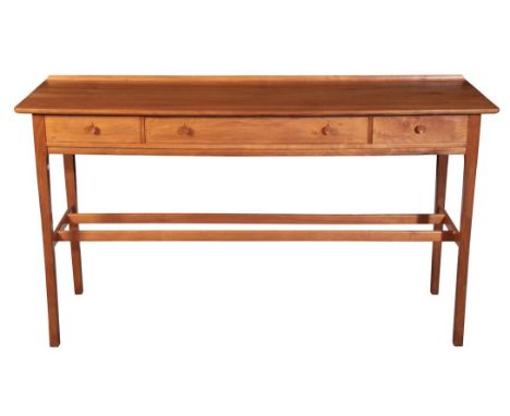 EDWARD BARNSLEY WORKSHOPS: A WALNUT CONSOLE TABLE the gently bow-fronted rectangular top with raised lip back, one long and t