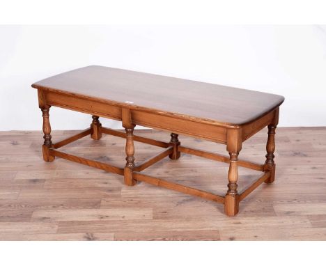 A Ercol elm coffee table, 115 x 50 x 41cms high