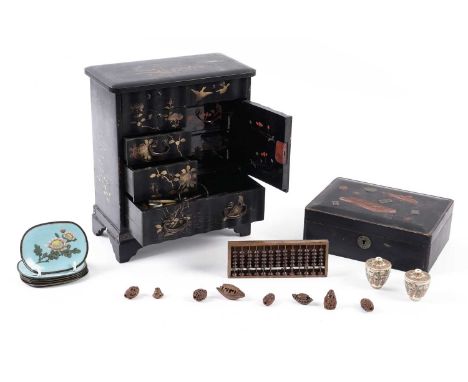 A 20th Century Japanese lacquered tabletop cabinet, decorated with gilt coloured finches and flowers, compartmentalised into 