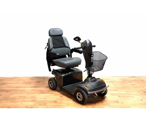 A Freerider electric mobility scooter, with basket, bag, user manual, and battery charger.