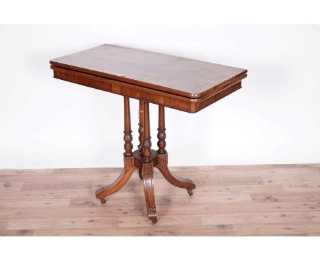 A Victorian rosewood card table, the 'D' shaped hinged swivel action top opening to reveal burgundy baize playing surface, ra