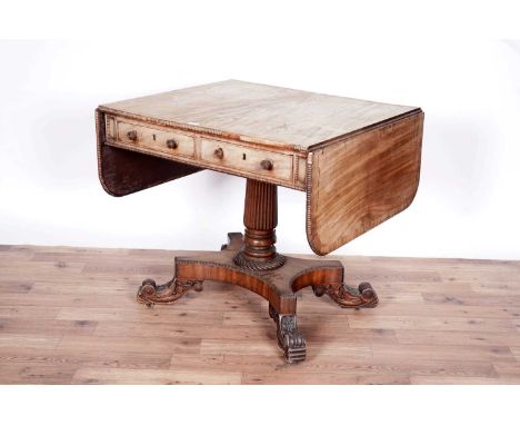 A late Regency mahogany sofa table, the rectangular double flap top with straight gadrooned border, above frieze with one rea